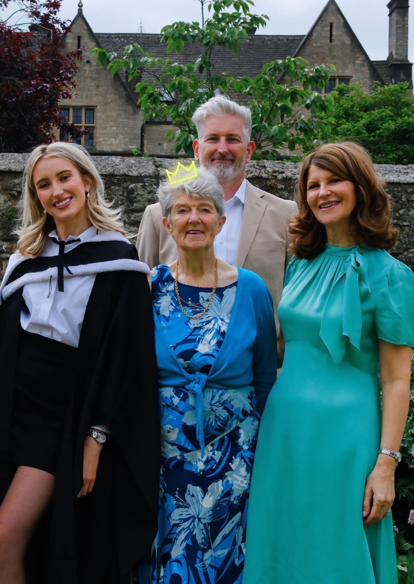 Hannah with her family and Grandma, wearing a neon crown