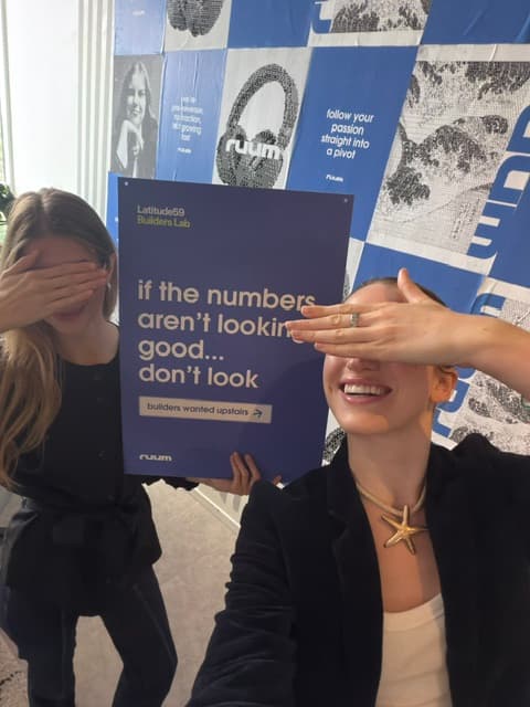 Hannah and Lotta covering their eyes with a 'if the numbers aren't looking good... don't look' sign