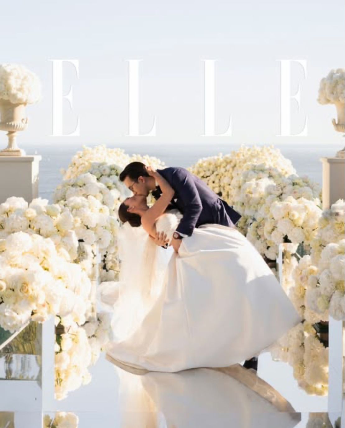 Elle-featured wedding planned by the Darcy team: couple kissing among white flowers